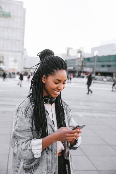 istock Young woman in Berlin texting on mobile 1395000253