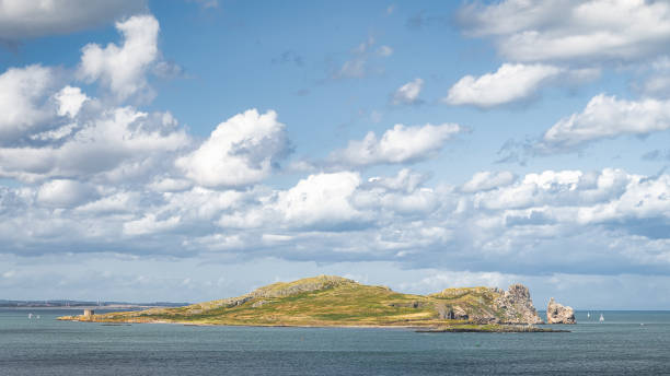 istock Small rocky island called Irelands Eye with Martello Tower 1395001325