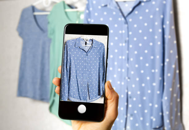 istock Clothing for sale online on a smartphone screen. 1395004246