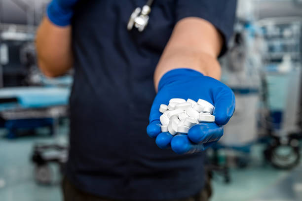 istock doctor in dark blue uniform holding a pills with stethoscope 1395006892