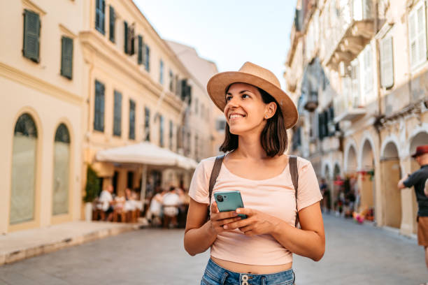 Young Female Tourist Enjoying The Greek Architecture Beautiful young female tourist enjoying the architecture of Corfu Town, Greece. greece travel stock pictures, royalty-free photos & images