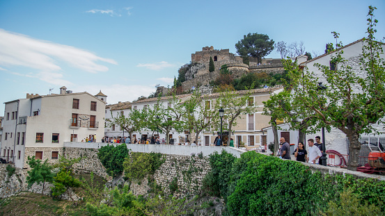 Guadalest , Alicante / España , March 17 , 2022 : Tourists visiting Guadalest or Castell de Guadalest, strolling through its alleys and taking photos