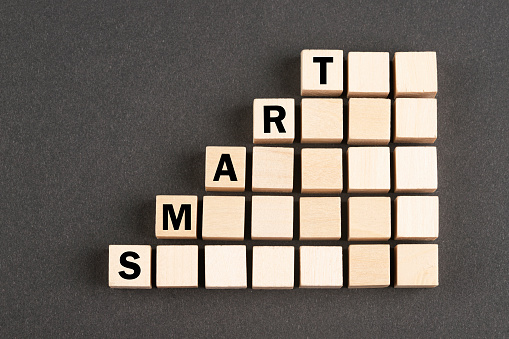 Wooden block cubes with word Smart on black background