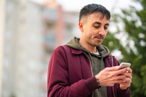 istock Young man using mobile phone outdoors 1395010862