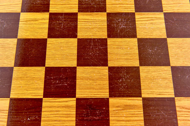 istock Chess game on a wooden board, chessboard texture background. 1395010988
