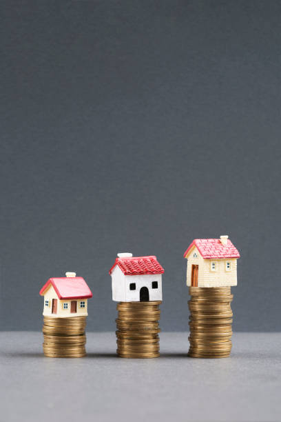 Coins and houses stock photo
