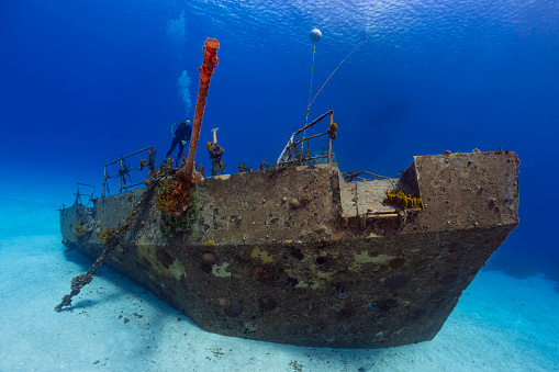 View of the MV Captain Keith Tibbetts shipwreck and a female diver in Cayman Brac - Cayman Islands