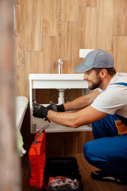 istock Professional plumber, male worker in uniform looking busy while fixing sink in apartment 1395015897