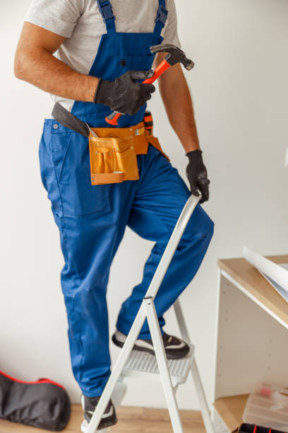istock Cropped shot of electrician in uniform using ladder, holding hammer while installing light fitting in new apartment 1395015928