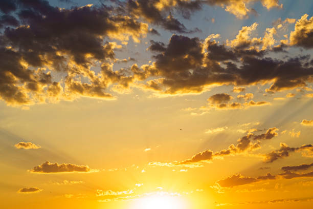istock Sunset with light cloud formations and orange colors 1395018157