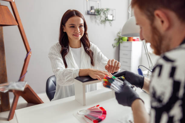 istock Joyful woman enjoying nail service in beauty studio 1395018915