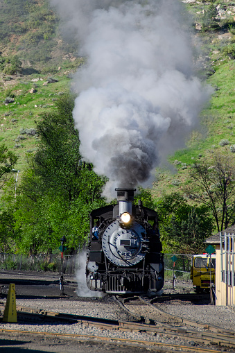 Coal burning K-36 steam locomotive moving toward camera on narrow gauge track.