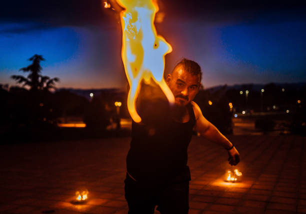 istock Fire artist with flaming torch 1395019243