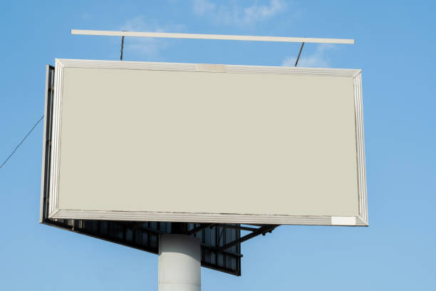 istock One single simple empty blank city street billboard advertisement, copy space, placeholder, blue sky background, nobody, no people. Marketing, outdoors advertising empty template, cut out 1395019684