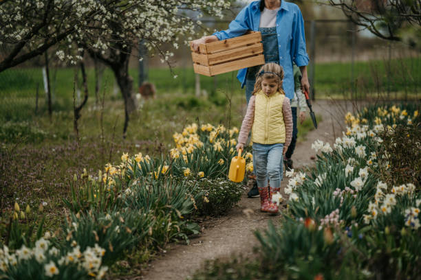 istock Girl going to water plants 1395023913