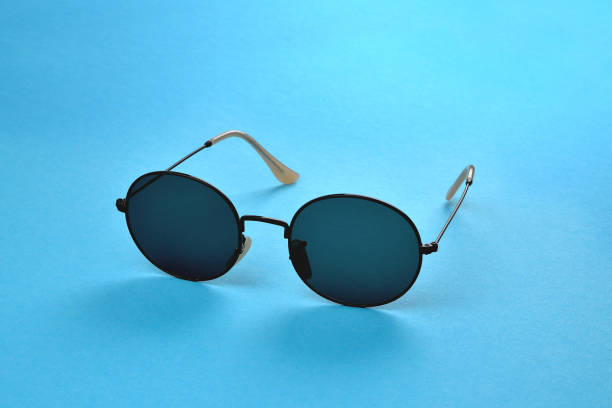 istock Glasses from the sun, stylish sunglasses on a blue background,  selective focus 1395024616