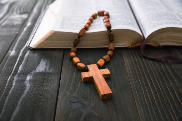 istock Holy Bible with wooden cross 1395026324