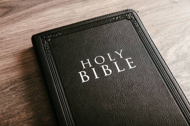 istock Holy Bible on the wooden table 1395026346