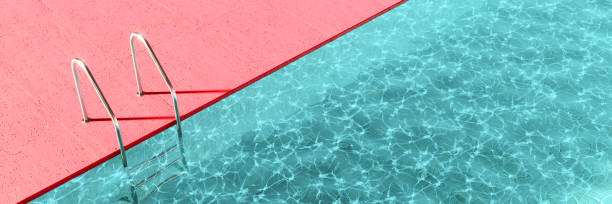 Turquoise blue modern pool with polished metal ladders and pink concrete decking