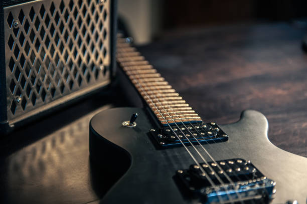 istock Close-up, black electric guitar on a dark background. 1395028197