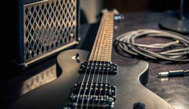 istock Close-up, black electric guitar on a dark background. 1395028203