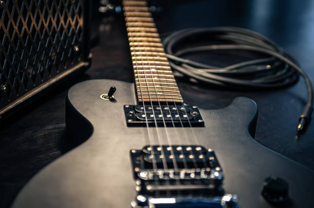 istock Close-up, black electric guitar on a dark background. 1395028205