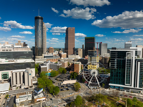 Downtown Atlanta on a sunny day, looking across Centennial Park towards the ferris wheel and downtown skyscrapers.