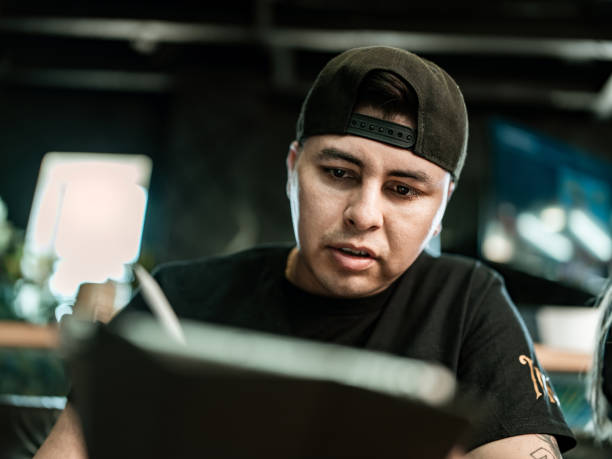 istock Mexican Tattoo artist sketching on digital tablet 1395031233