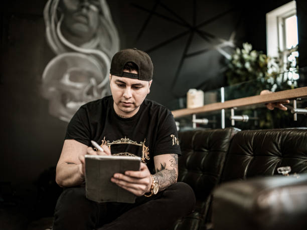 istock Mexican Tattoo artist sketching on digital tablet 1395031315