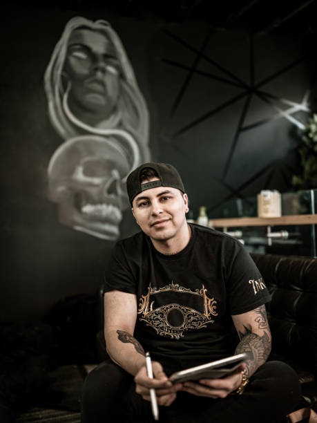 istock Mexican Tattoo artist sketching on digital tablet 1395031871