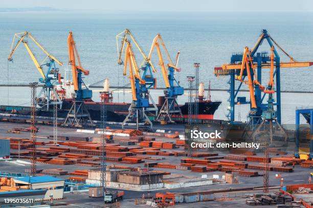 Sea Commercial Port At Night In Mariupol Ukraine Before The War Industrial Cargo Freight Ship With Working Cranes Bridge In Sea Port At Twilight Cargo Port Logistic Heavy Industry Stock Photo - Download Image Now
