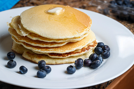 a stack of homemade pancakes with fresh blueberries