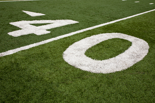 Football field stadium yard line marker on stadium field.