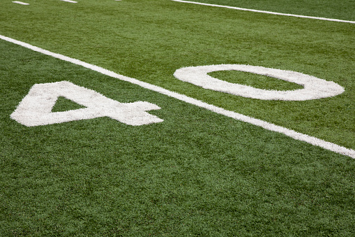 Football field stadium yard line markers on stadium field.