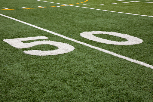 Football field stadium yard line markers on stadium field.