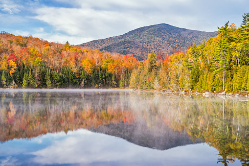 Heart Lake near Lake Placid in the Adirondack Mountains, New York State, USA, on a misty morning during Fall colors.
