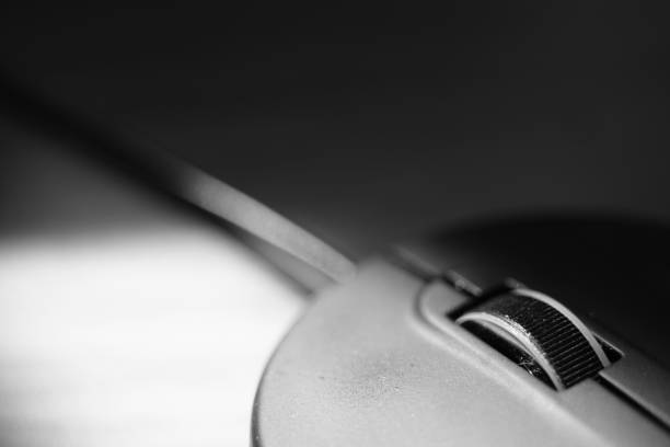 istock Closeup view of pc mouse on the table. BW photo. 1395047543