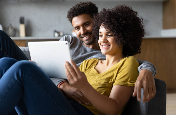 istock Loving couple at home streaming on a tablet 1395058383