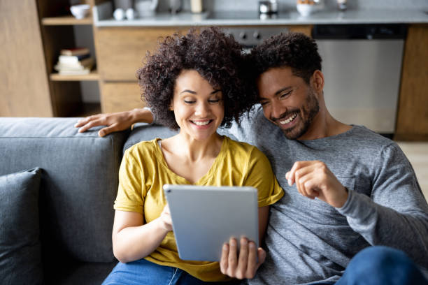 istock Happy couple at home using a tablet 1395058392