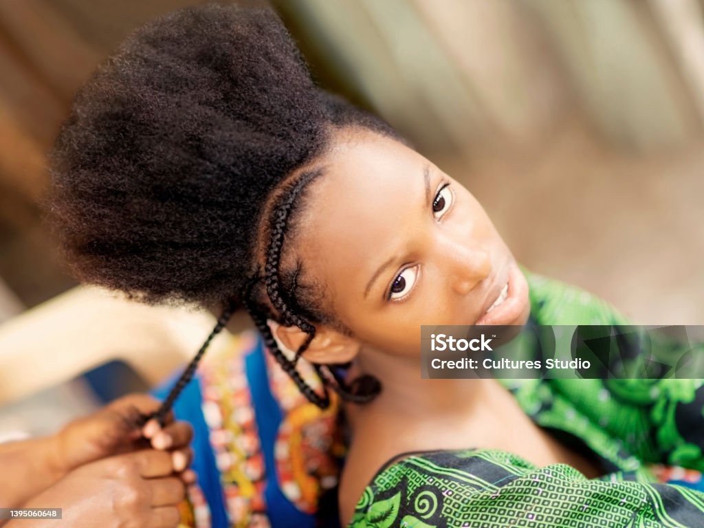 Young afro beauty being braided, teenage girl, eighteen years old African Ethnicity Stock Photo