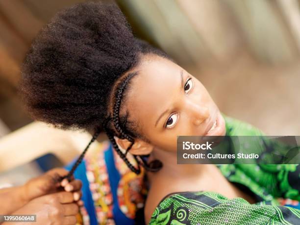 Young Afro Beauty Being Braided Teenage Girl Eighteen Years Old Stock Photo - Download Image Now