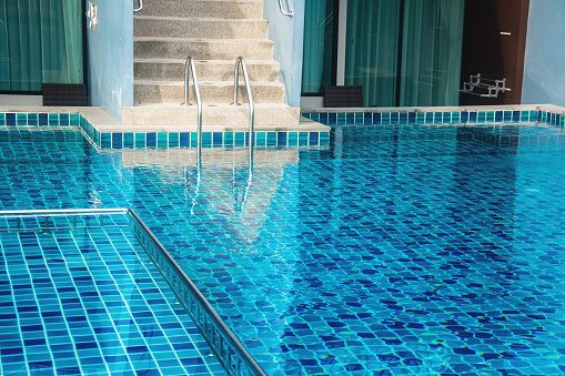 stair of swimming pool with blue water