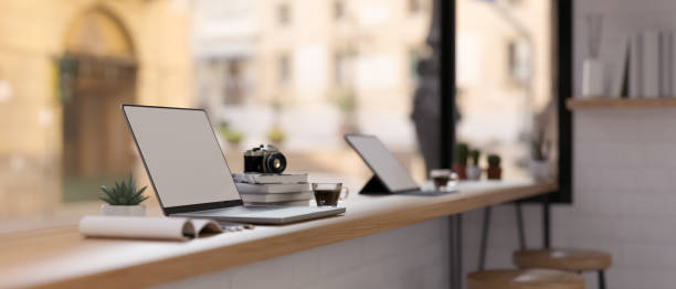 istock Modern minimal coffee shop co-working space interior design with open laptop 1395064463