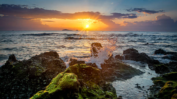 istock sunset landscape on the beach rocks in foreground 1395070877