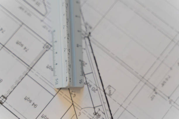 istock Architectural Scale Ruler with paper blueprints plans for new building 1395074600