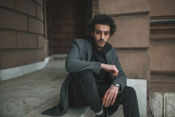 istock A handsome man is sitting on the stairs 1395078085