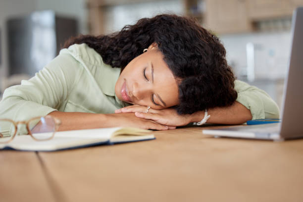 istock Shot of a young woman sleeping at a table while working from home 1395081674