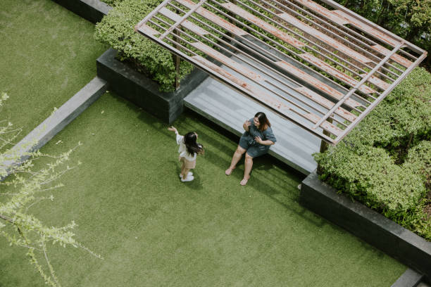 istock Happy two Asian dreads while relaxing and resting in the green common area. 1395081979
