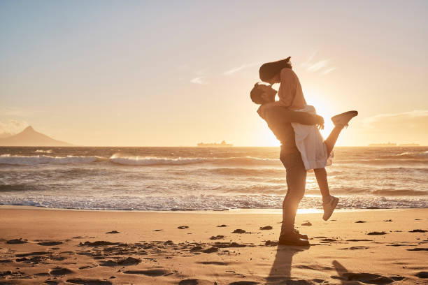 istock Young diverse biracial couple having fun at the beach together 1395082732