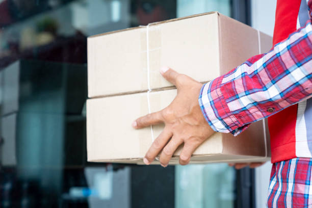 istock Delivery man sending parcels box to customer. 1395082875